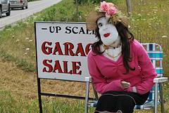 garage sale sign with doll