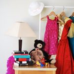 Clothes hanging on a rack at a yard sale