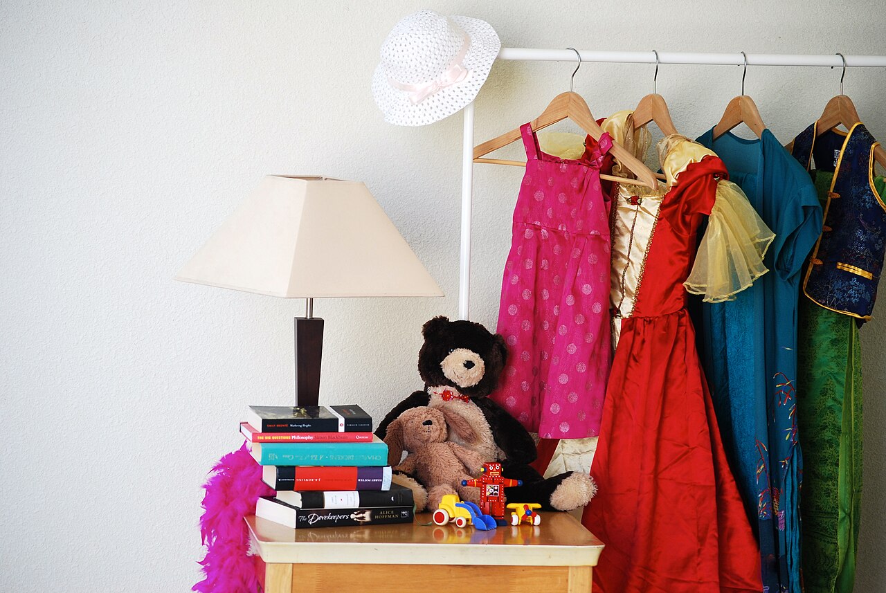 Clothes hanging on a rack at a yard sale