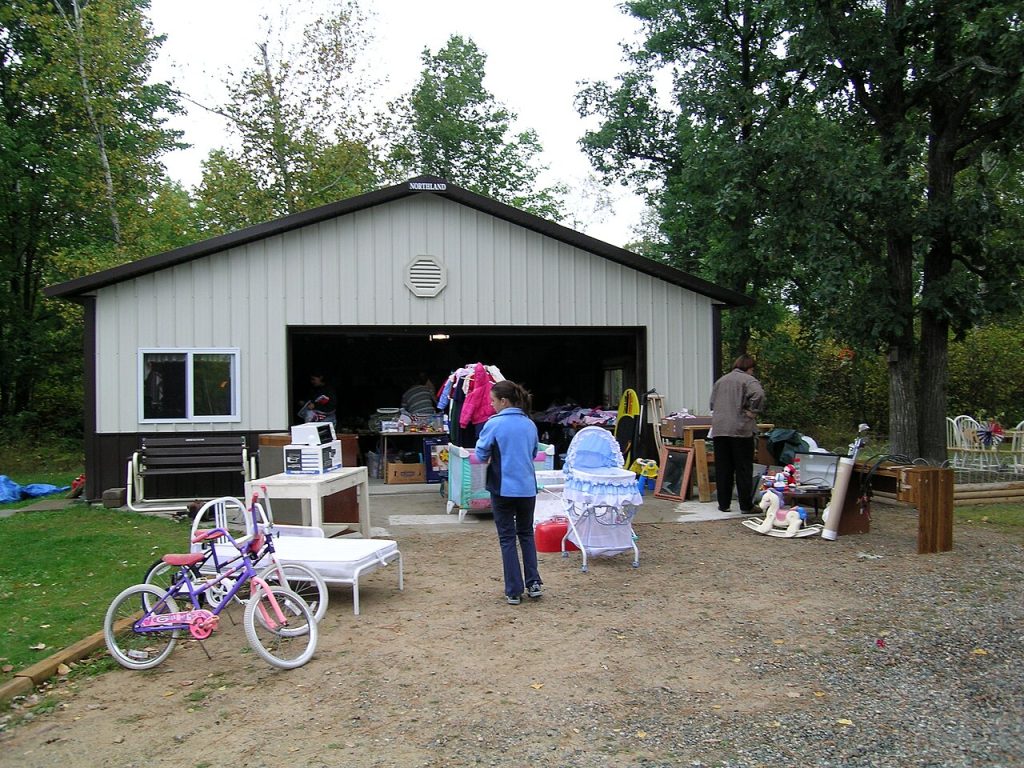 Shoppers browsing a driveway garage sale