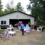 Shoppers browsing a driveway garage sale